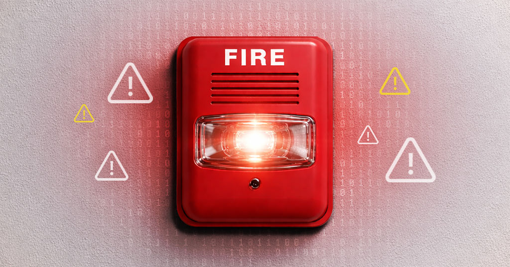 IT Fire Drill Warning — Proactive Managed IT for Florida Businesses A red fire alarm with a glowing strobe light mounted on a wall, surrounded by warning triangles and a digital binary code overlay, representing the IT fire drills Florida businesses face when small tech problems go unaddressed.